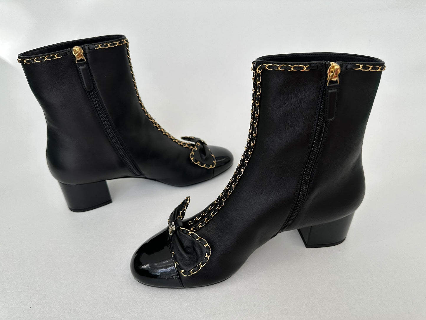 CHANEL 24B BLACK LAMBSKIN LEATHER SHORT BOOTIES WITH GOLD CHAINS AND BOW ANKLE SHORT BOOTS