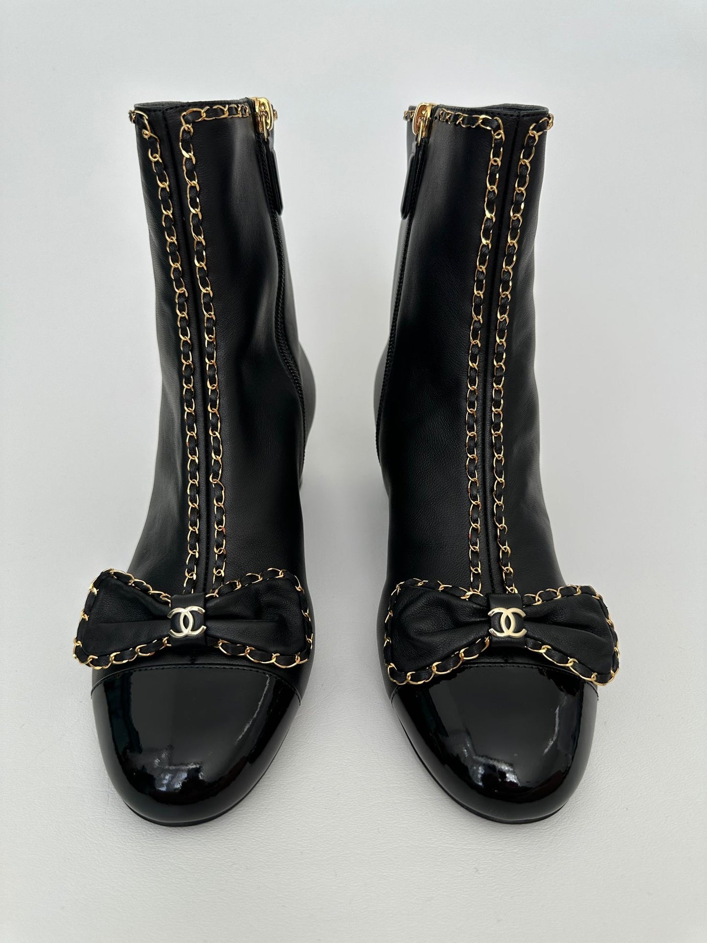 CHANEL 24B BLACK LAMBSKIN LEATHER SHORT BOOTIES WITH GOLD CHAINS AND BOW ANKLE SHORT BOOTS