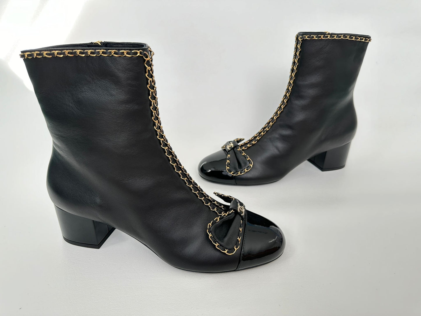 CHANEL 24B BLACK LAMBSKIN LEATHER SHORT BOOTIES WITH GOLD CHAINS AND BOW ANKLE SHORT BOOTS