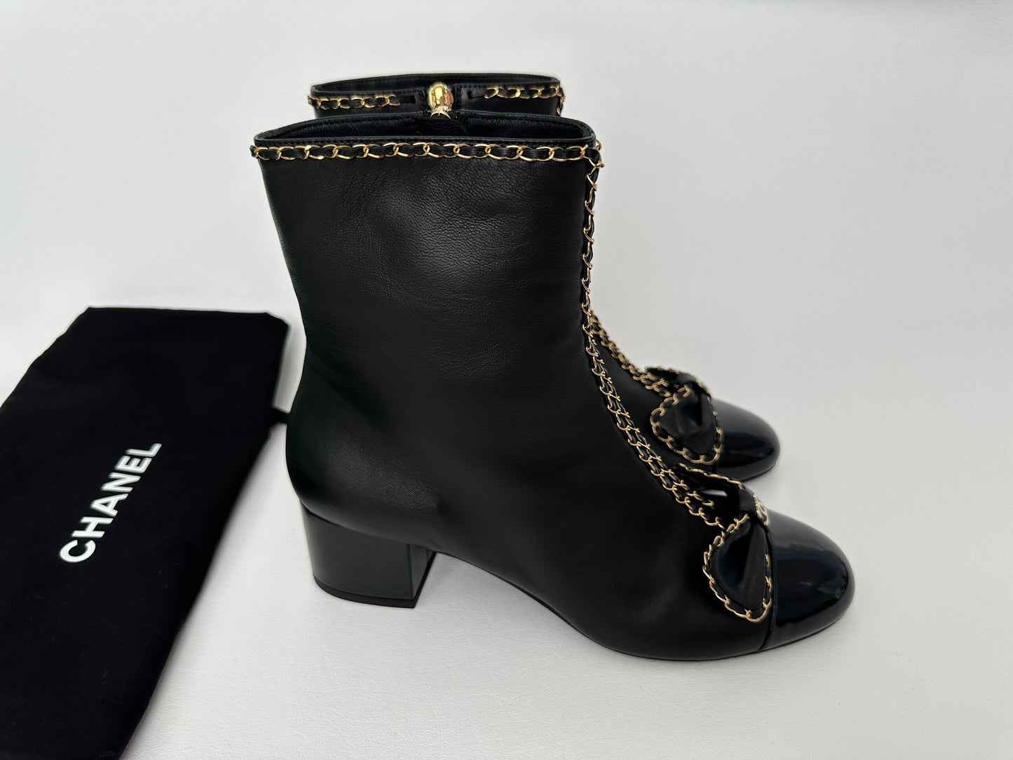 CHANEL 24B BLACK LAMBSKIN LEATHER SHORT BOOTIES WITH GOLD CHAINS AND BOW ANKLE SHORT BOOTS