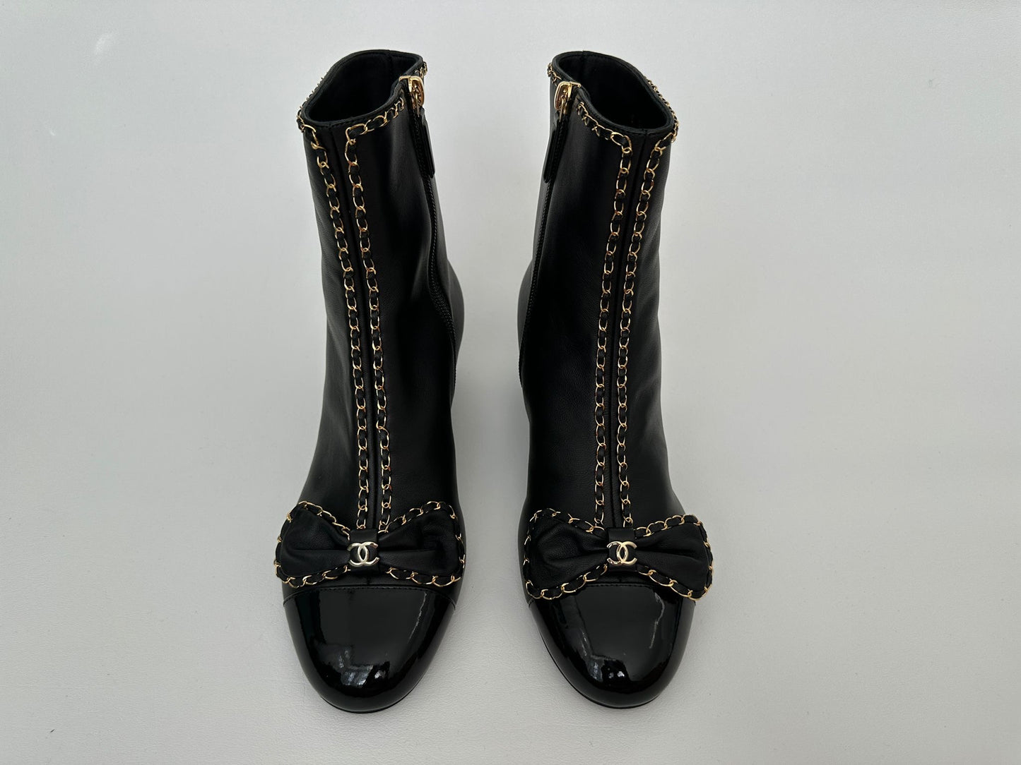 CHANEL 24B BLACK LAMBSKIN LEATHER SHORT BOOTIES WITH GOLD CHAINS AND BOW ANKLE SHORT BOOTS